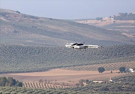 A Vtol passenger aircraft, on a test flight above an olive grove in Andalucía.