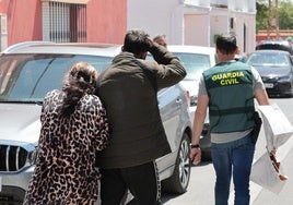 Relatives of the wanted man, with Guardia Civil officers.