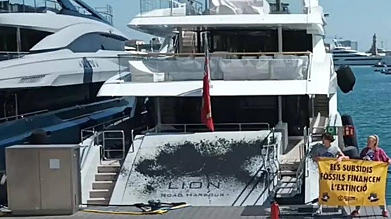 Climate activists spray black paint on mega-yachts in Barcelona harbour