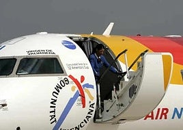 An Air Nostrum cabin crew member leaving the plane.