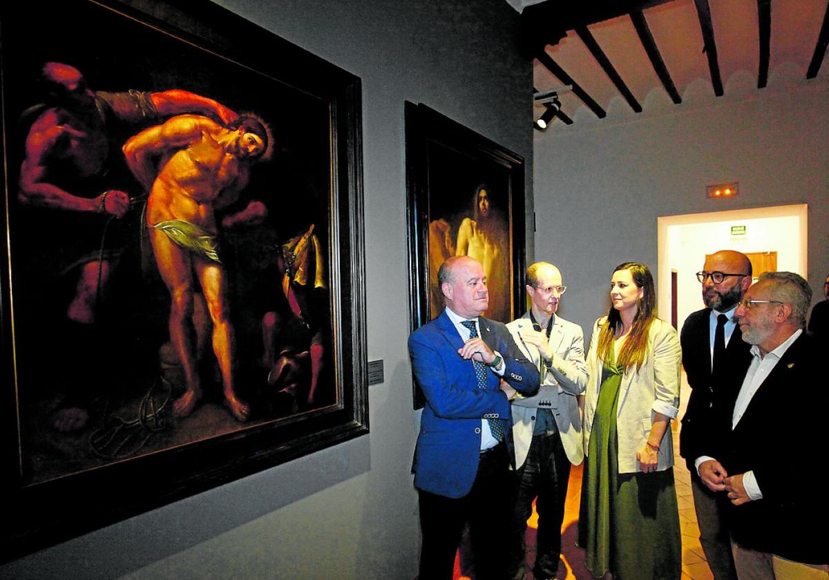 Officials stand in front of Preparativos para la Flagelación de Cristo by Vicente Carducho.