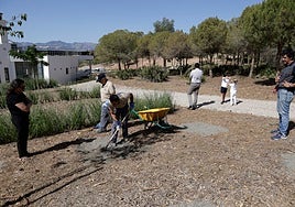 Michele and Juan Antonio, the owners of Choco, an American cocker spaniel, watch as two workers dig the grave for their beloved pet.