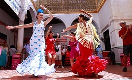 Women dance Sevillanas at Malaga feria in a photo taken last summer.