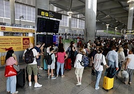 Passengers anxiously watching the flight information screens at Malaga Airport today.