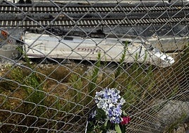 Flowers in front of the wreckage of the train wreckage