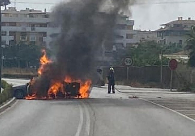 The car, engulfed in flames, on the old N-340 in Torre del Mar, on Monday.