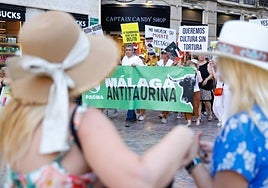 Tourists watch the demonstration as it passes through the Plaza de la Constitución on Saturday.
