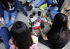 A 'botellón': young people gather on a street to socialise and drink alcohol.