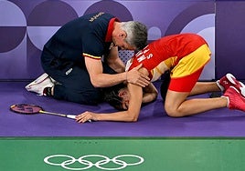 Marín is comforted by her coach.