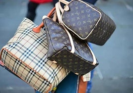 Several counterfeit luxury-brand handbags.