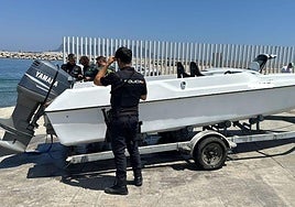 Police inspect a boat used for drug trafficking.