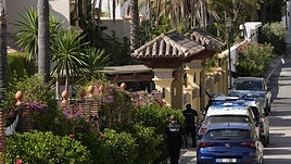 Two National Police officers in the vicinity of the villa where the shooting took place.
