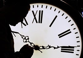 A clockmaker changes the time.