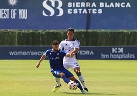 Bernardo, Marbella defender, tries to steal the ball from a Ceuta player.