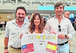Rotarians Federico Vallés and Alberto García, with Cristina Lima, foster mother, waiting at Malaga Airport.