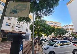 Vehicles parked next to a parking meter.
