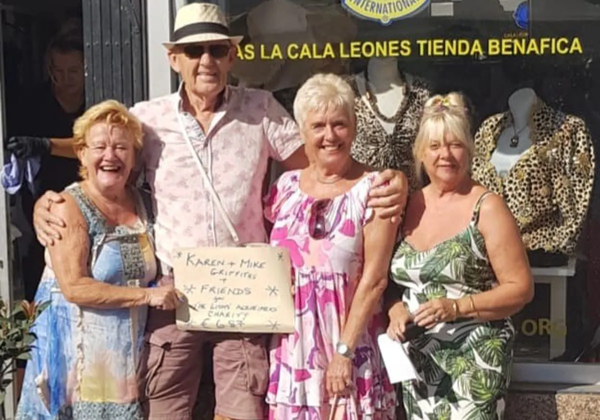 Mike and Karen (c) present the cheque to the Lions.