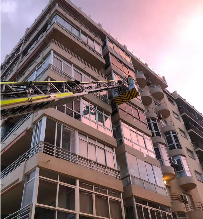 Firefighters working at the fifth-floor level.
