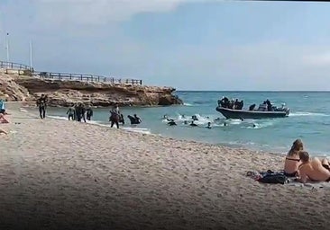 This is the moment a boat dropped around 40 migrants on a busy Costa del Sol beach, before speeding off