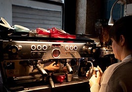 A worker at La Finca Coffee preparing a beverage.