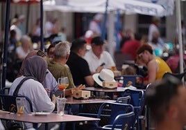 Bar and restaurant terraces full of tourists.