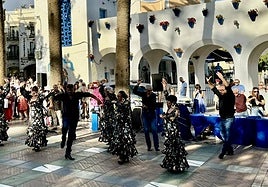 People watch a flamenco show on the Balcón de Europa.