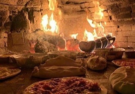 Pizzas and breads cooking in the wood-fired oven.