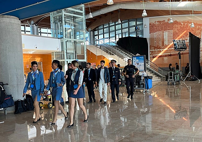 A group of extras dressed as cabin crew, pilots and police officers, before filming.