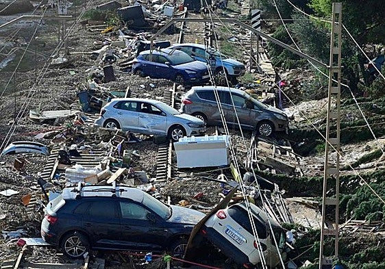 Wrecked cars piled up on the railway track in the town of Alfafar, in the Valencia region.