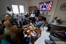 Democrat supporters watch the election results.