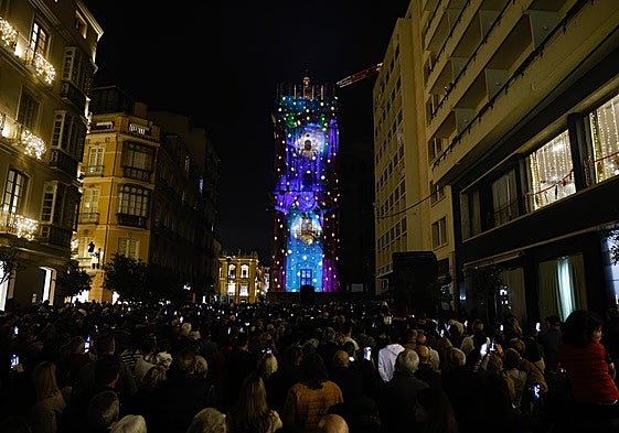 Hundreds of people record the videomapping show on Malaga's cathedral with their mobile phones.