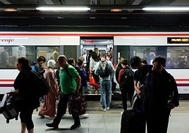 Passengers get on and off a Cercanías local train.