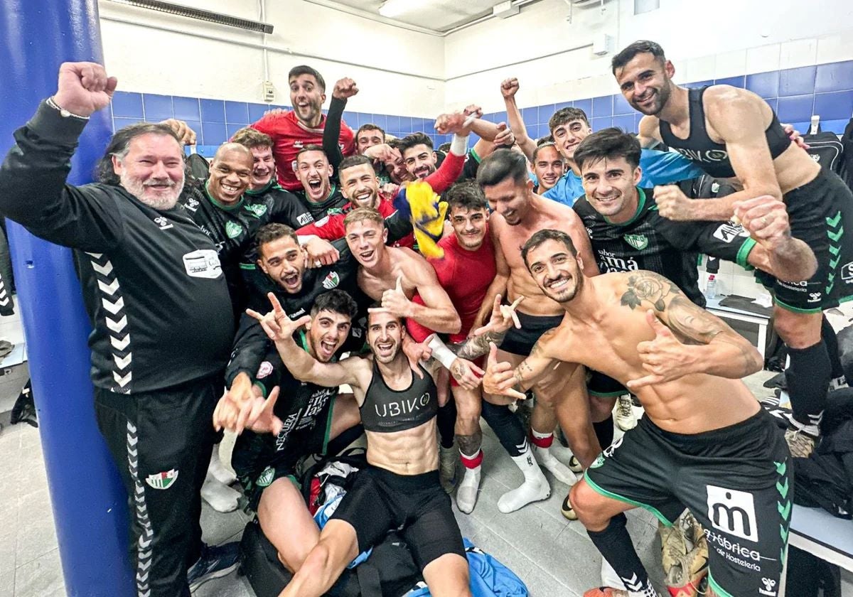 Celebrations in the away dressing room following the game.