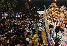 Spectators try to catch the sweets as they are thrown from the cavalcade in Malaga city.