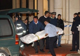 The bodies being removed from the scene.