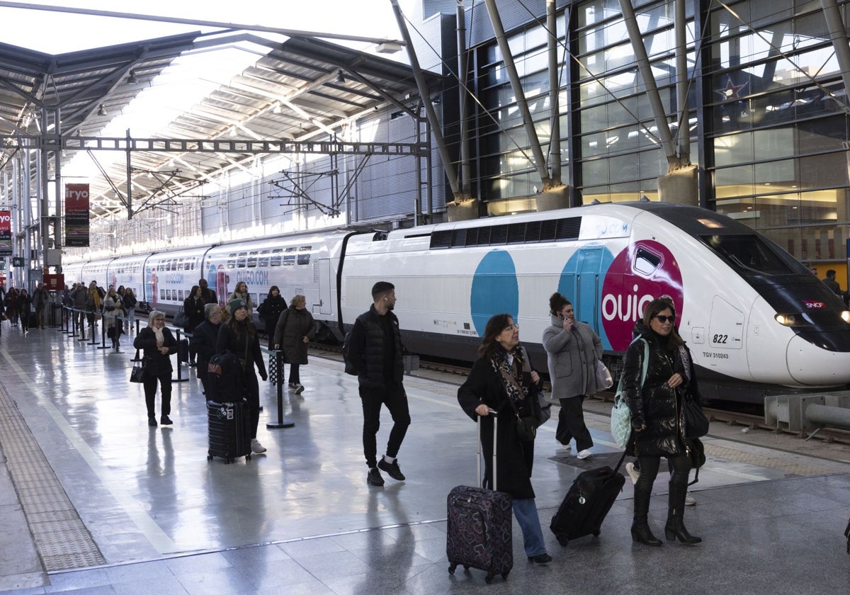 Rail passengers walk past the first Ouigo train this week at María Zambrano station in Malaga.