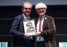 Malaga Festival's director, Juan Antonio Vigar, receives the award on behalf of the film festival being recognised as a cultural insignia of Andalucía from Alberto Fesser.
