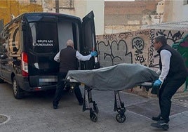 The body of the priest being removed from the building where he was renting an apartment
