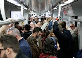 Passengers packed inside a Cercanías commuter train carriage on the C1 service between Malaga city and Fuengirola.