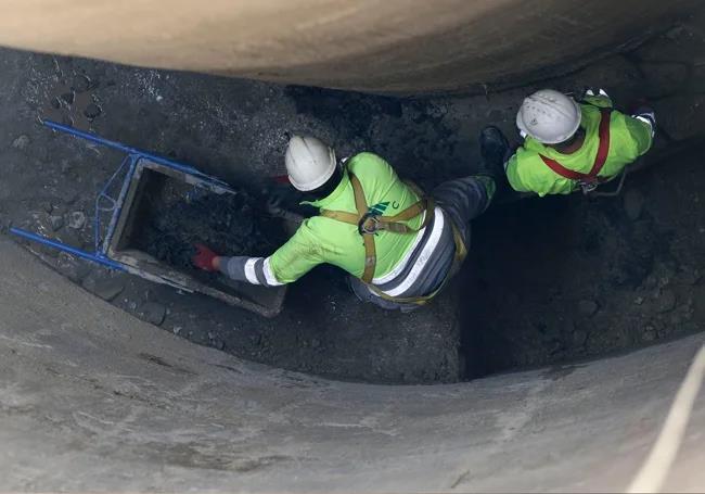 Two workers inside the structure.