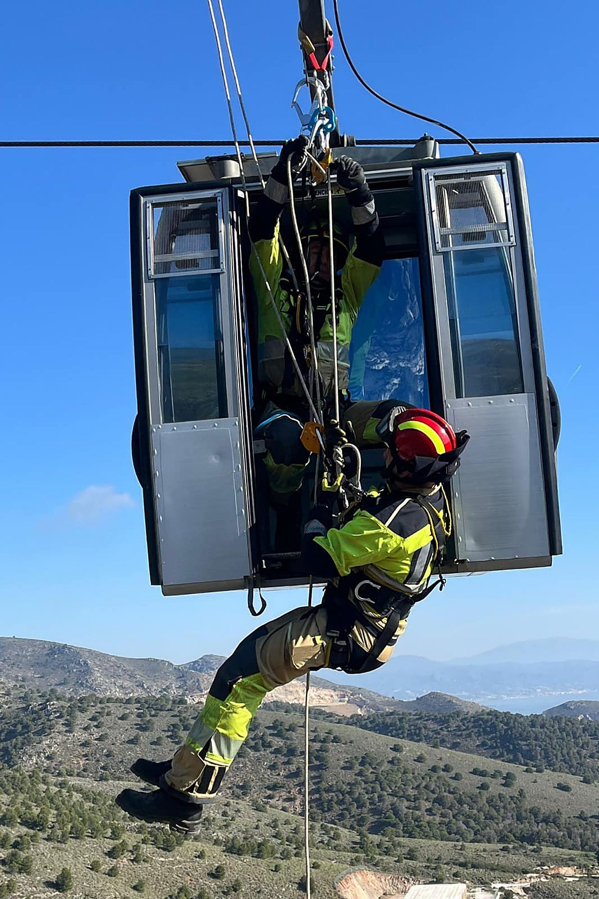 Firefighters work inside one of the cable cars.