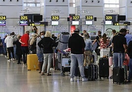 File image of passengers waiting to check in their luggage.