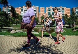 A group of pensioners stroll through a park in Madrid.