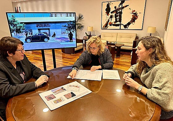 Ana Mula (c) studies the plans of the new day centre.