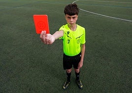 Aitor, the 13-year-old referee, showing a red card.