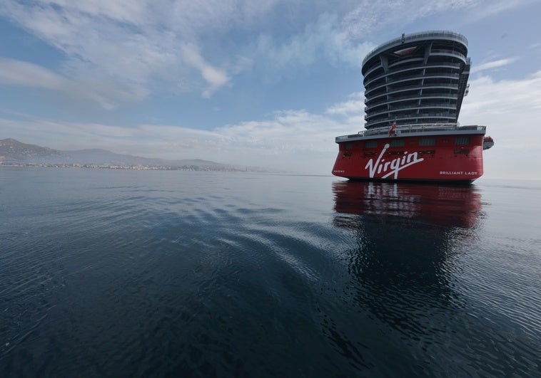 The Virgin Voyages cruise ship, anchored in Malaga's bay.
