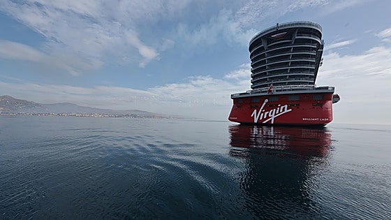 Why has a new Virgin luxury cruise ship extended its stay in a Costa del Sol bay?