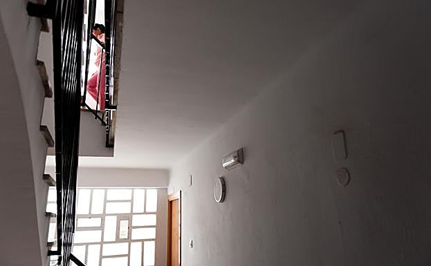 Andrea walking up the stairs of the building towards home.