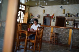 A woman at Jairo's bar, the only one in Bayubas de Abajo.