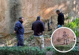 Workers from the Patronato de la Alhambra y el Generalife during the process of erasing the graffiti.